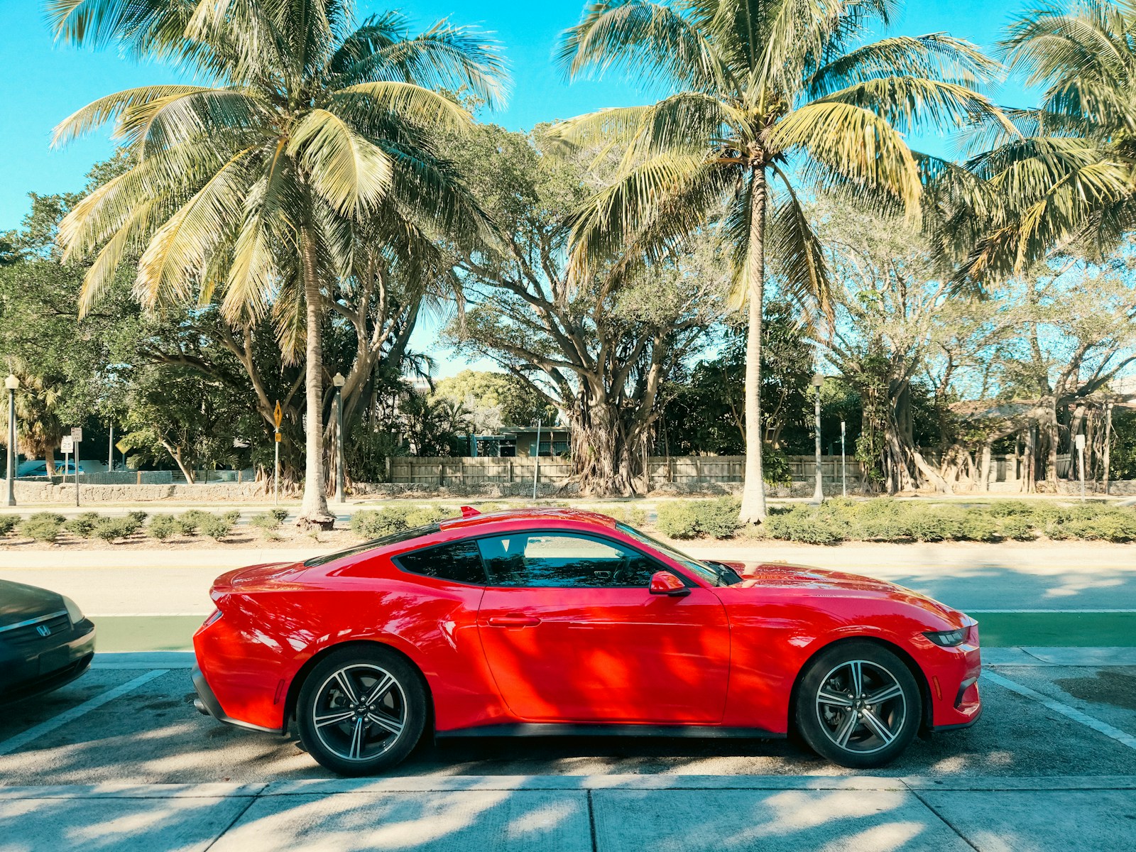 A red sports car parked in a parking lot